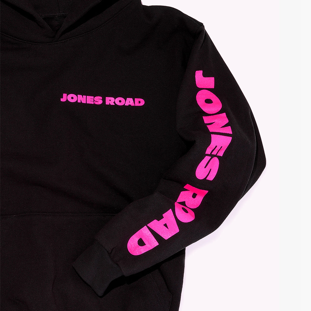 Jones Road Beauty's The Hoodie, in black with pink lettering